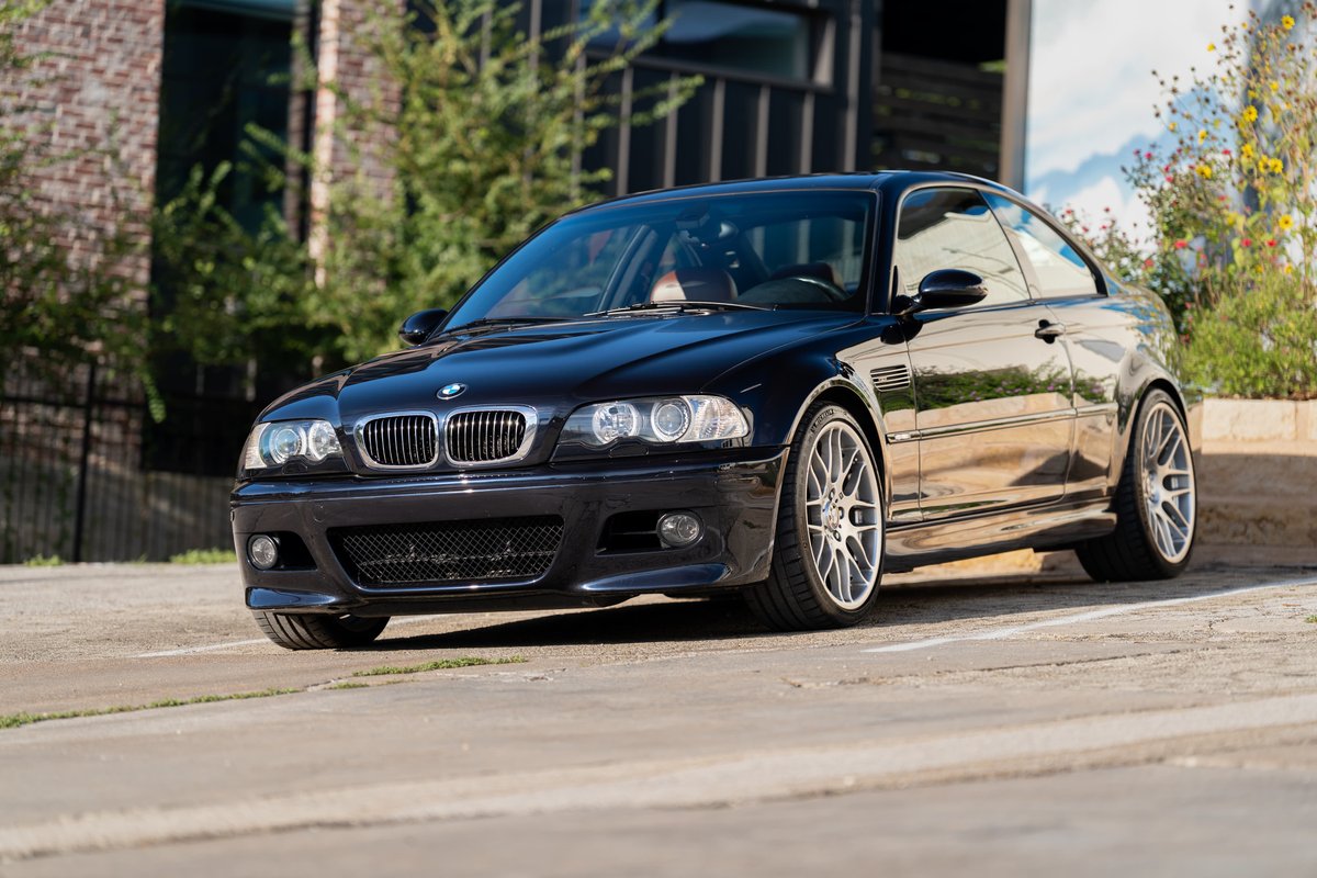Black 2002 BMW M3 coupe with silver alloy rims and performance tires.