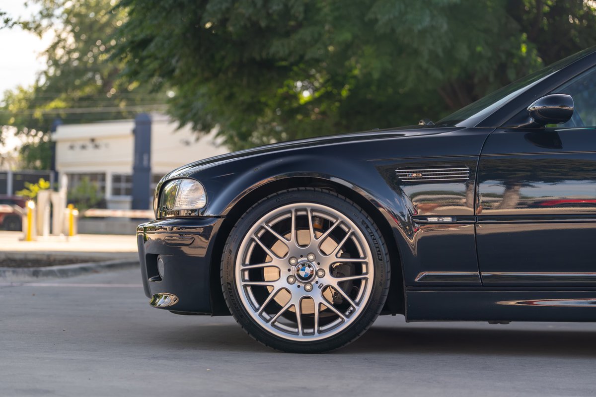 Carbon Black 2002 BMW M3 E46 front quarter panel and iconic M-style rims.