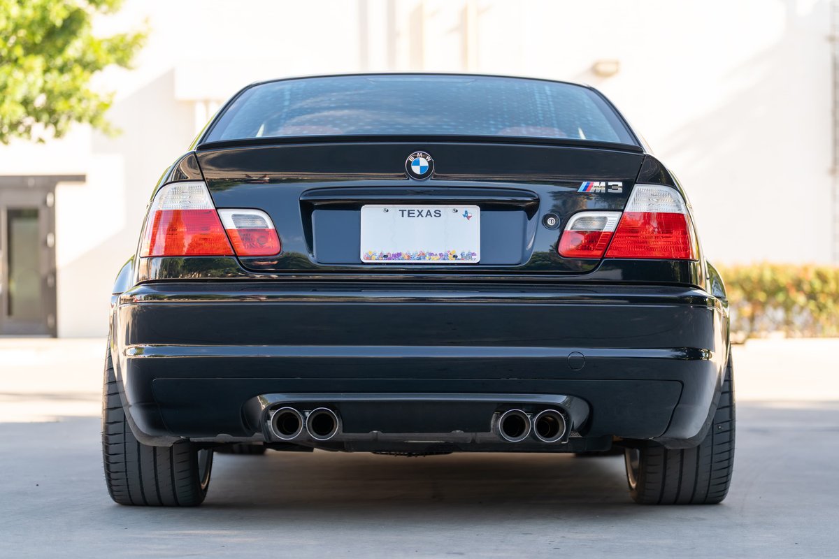Black 2002 BMW M3 E46 rear view. Quad exhaust tips, M3 trim, Texas license plate.