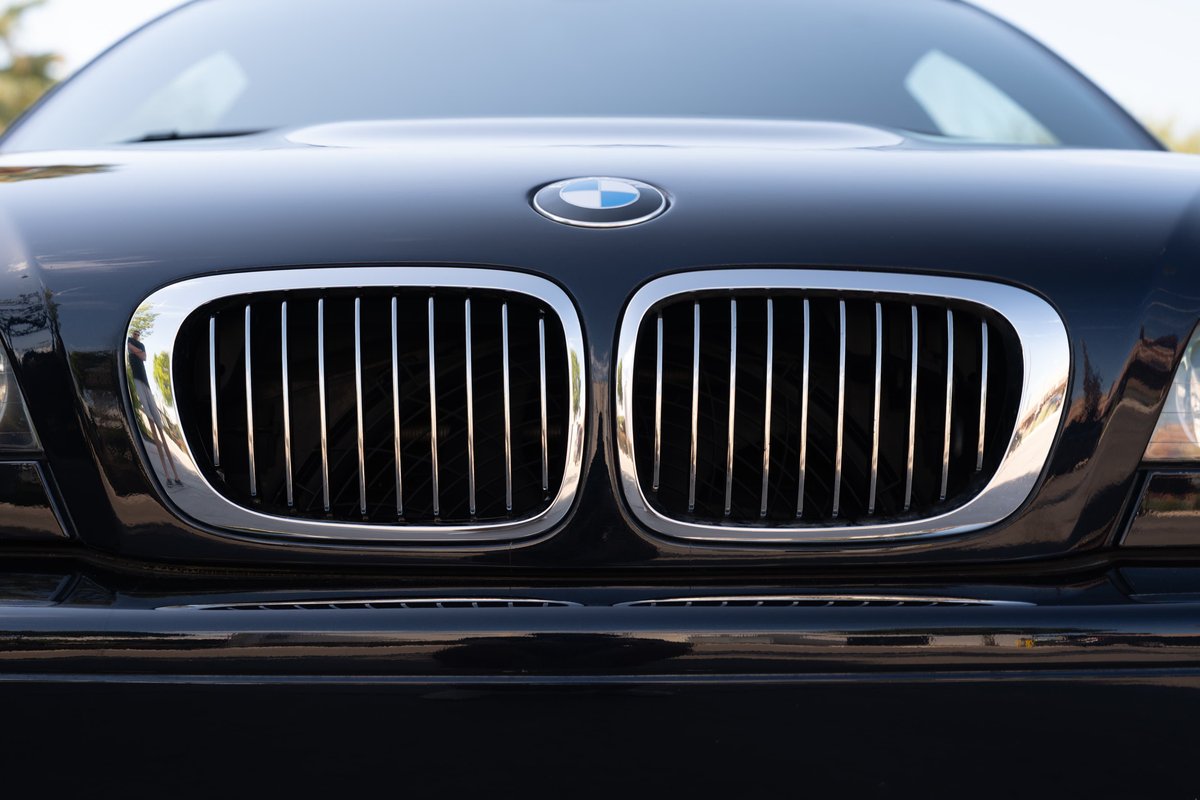 Close-up of the chrome kidney grille on a black 2002 BMW M3.