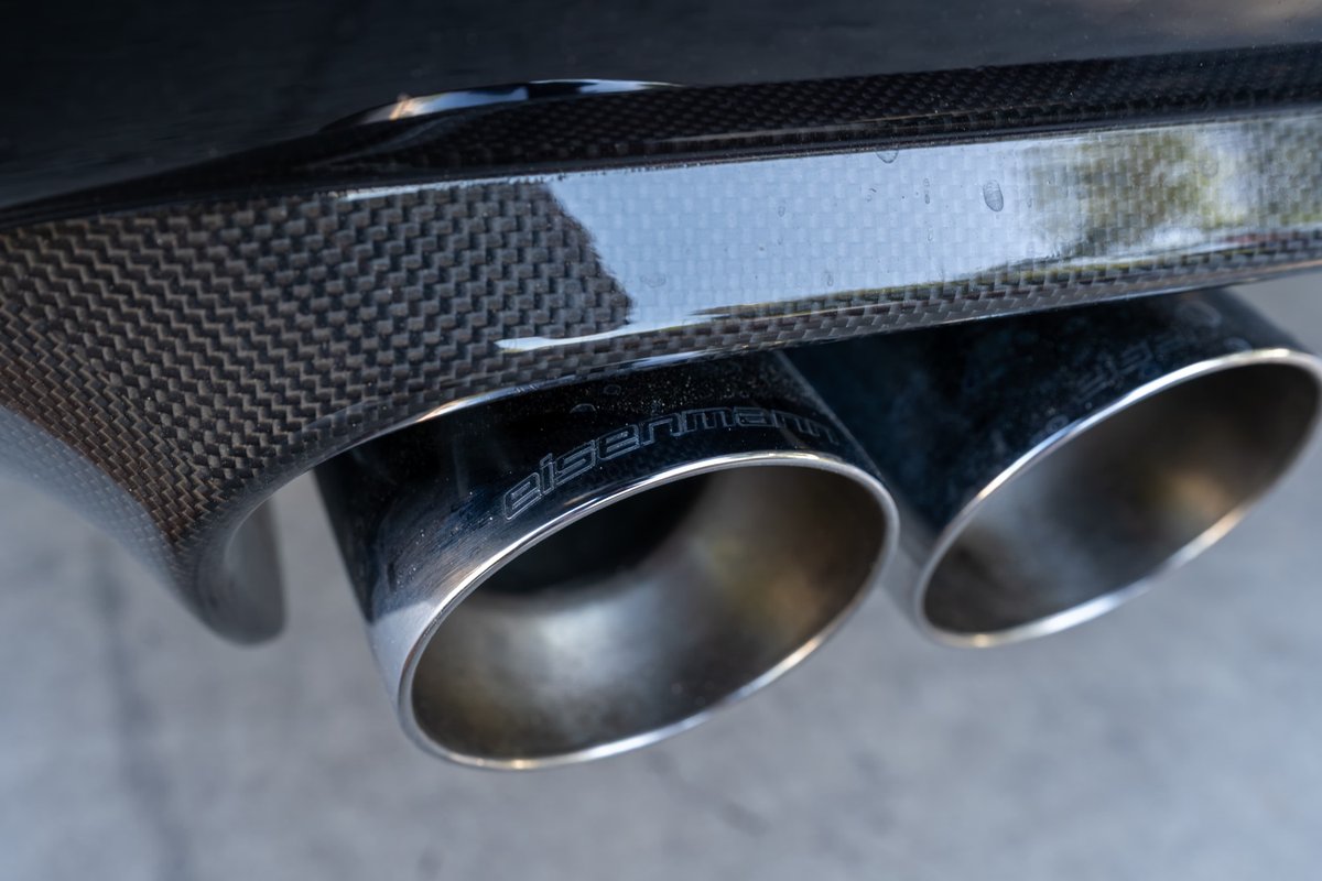 2002 BMW M3 with carbon fiber trim and Eisenmann exhaust tips.