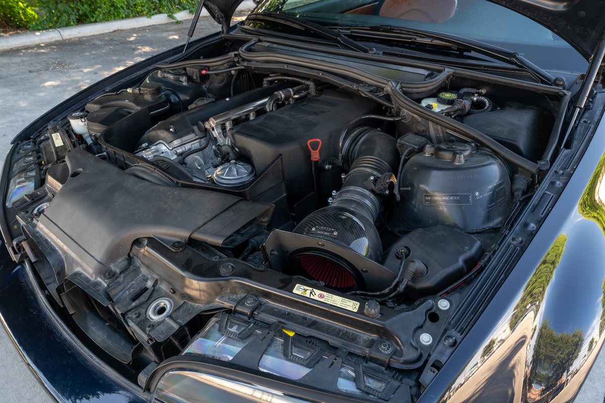 Carbon Black 2002 BMW M3 engine bay with aftermarket intake.