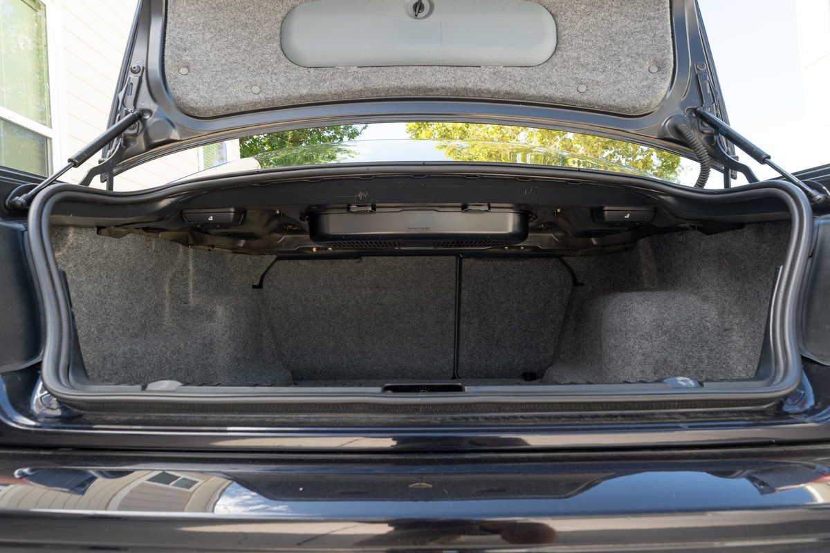 Trunk interior of a black 2002 BMW M3 convertible.