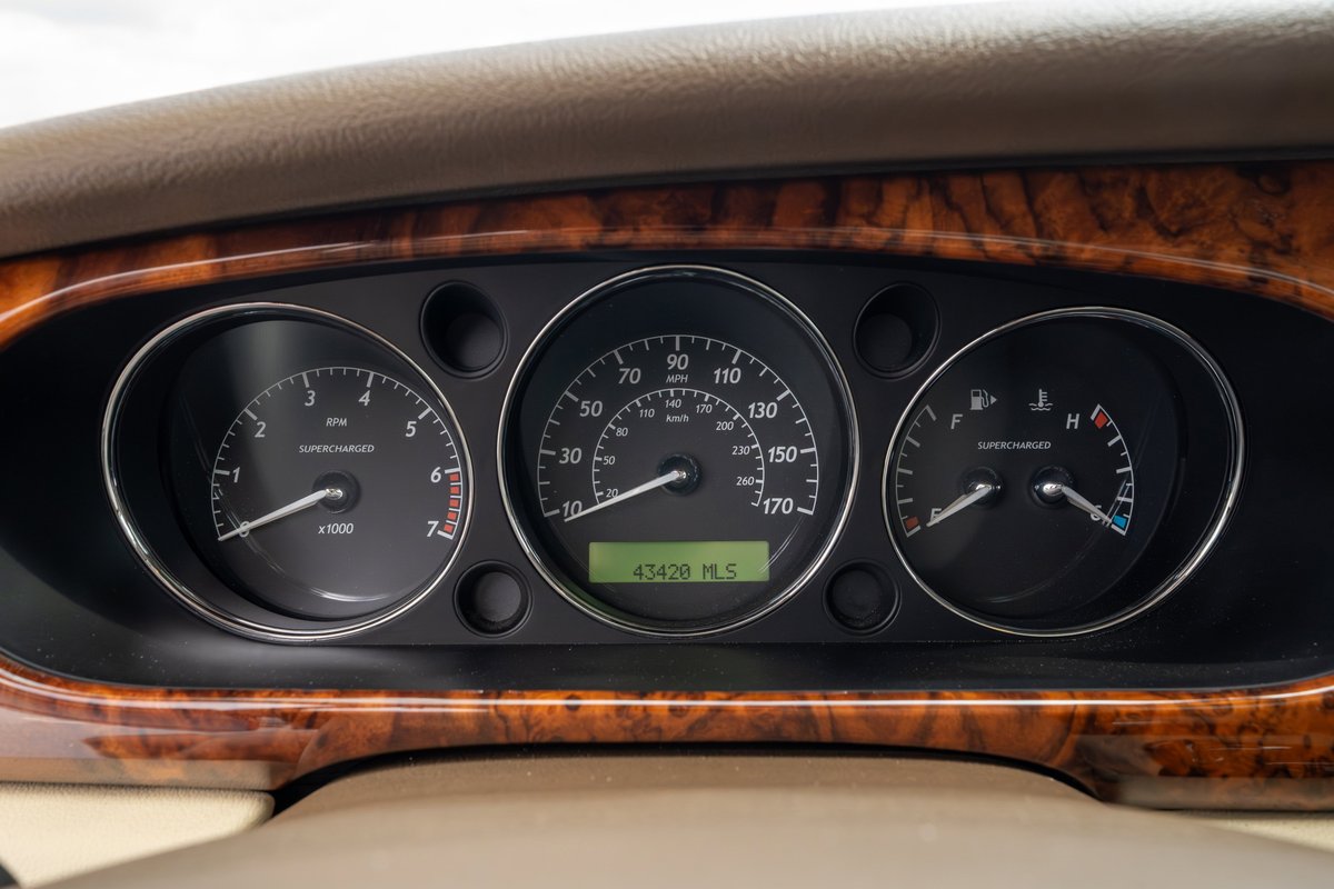 2006 Jaguar XJR dashboard with wood trim, showing 43,420 miles.