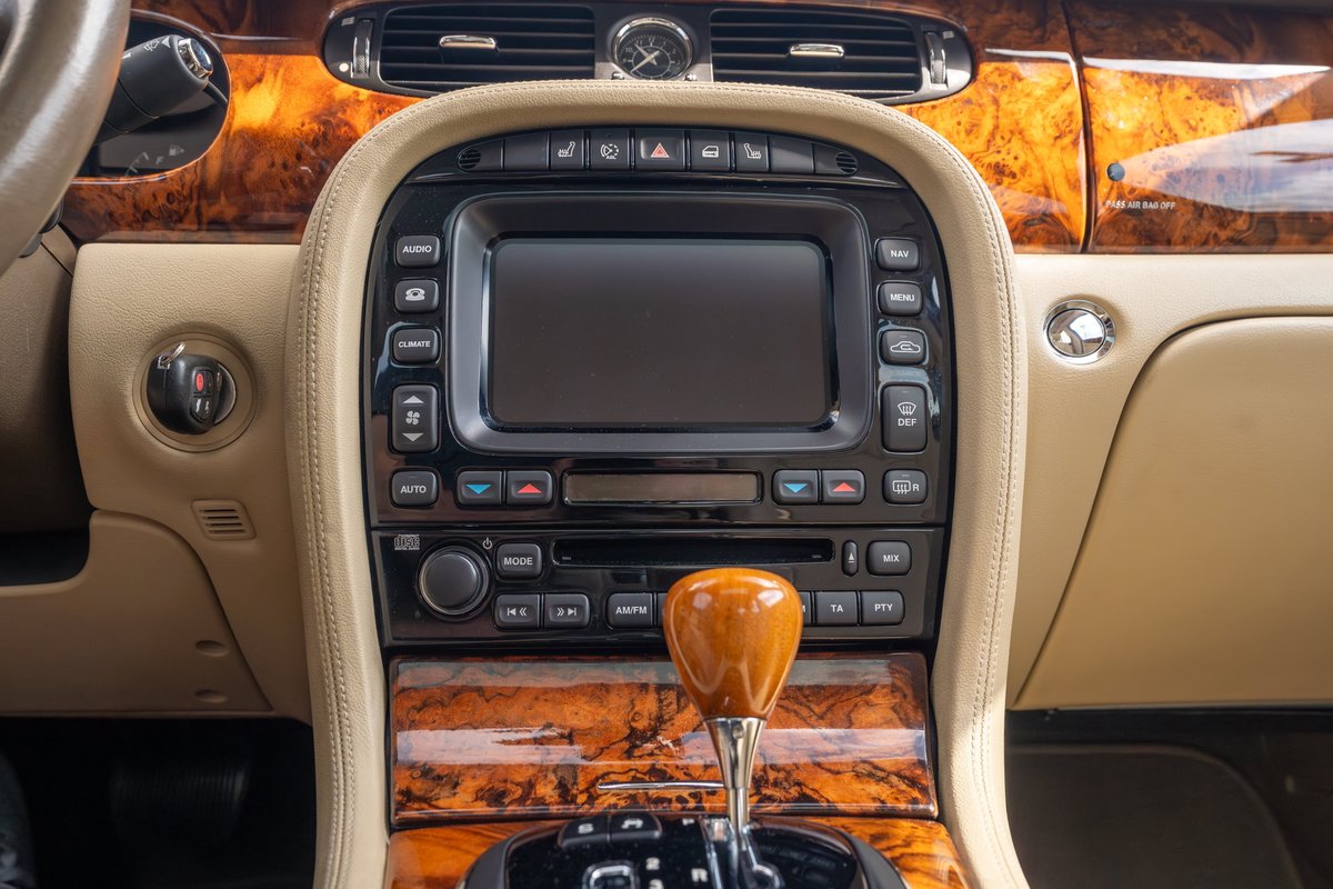 2006 Jaguar XJR interior with wood trim, leather accents, and a wood shift knob.