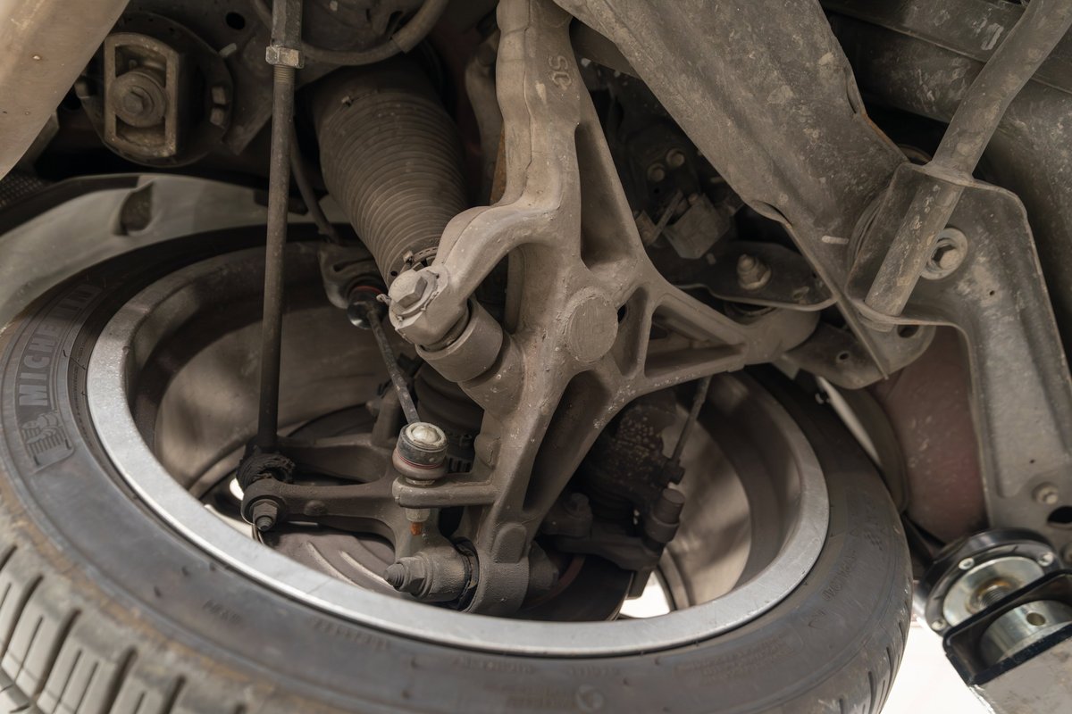 Underside view of a 2006 Jaguar XJR's front suspension system with a Michelin tire.