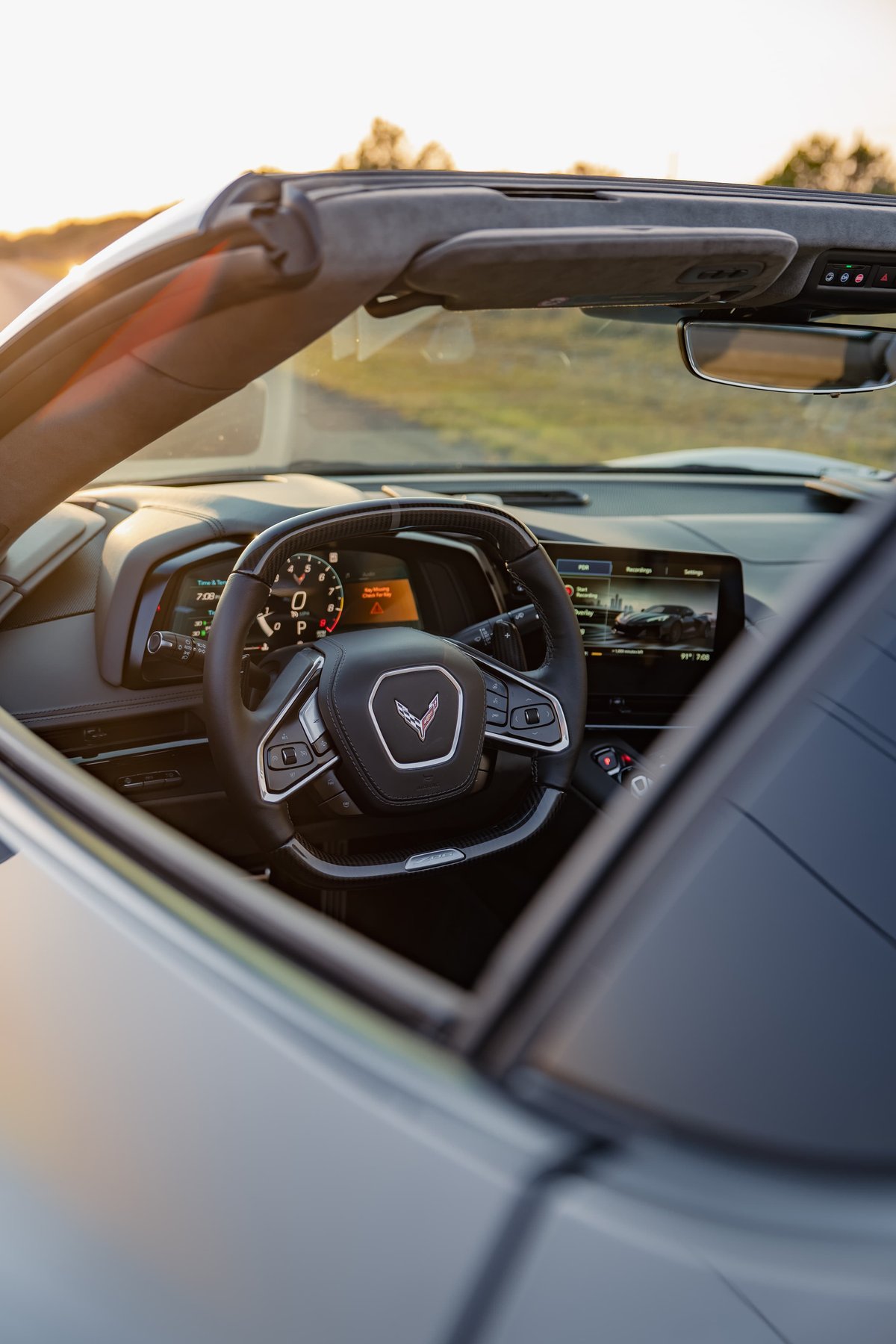 2025 Chevrolet Corvette Z06 interior in Sea Wolf Gray. Digital dash, infotainment screen, steering wheel.