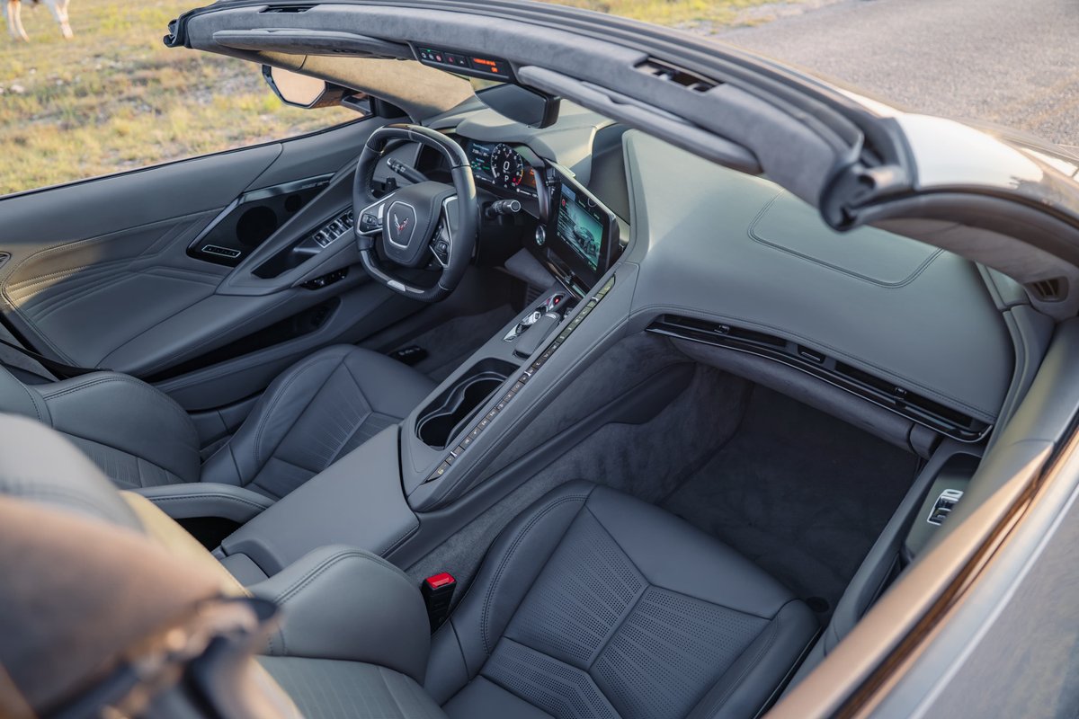 Interior of a gray 2025 Chevrolet Corvette Z06 convertible with leather seats and a digital dashboard.