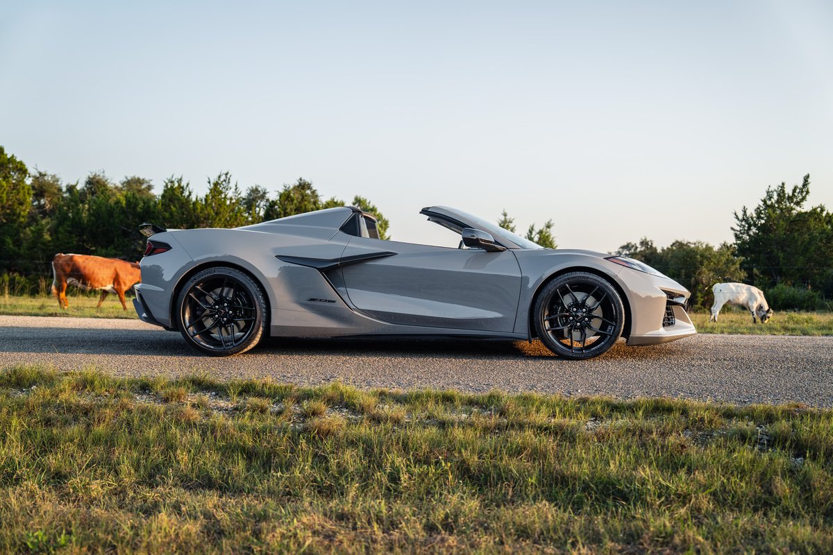 2025 Corvette Z06 convertible in Sea Wolf Gray, black rims, low profile tires, rear spoiler.