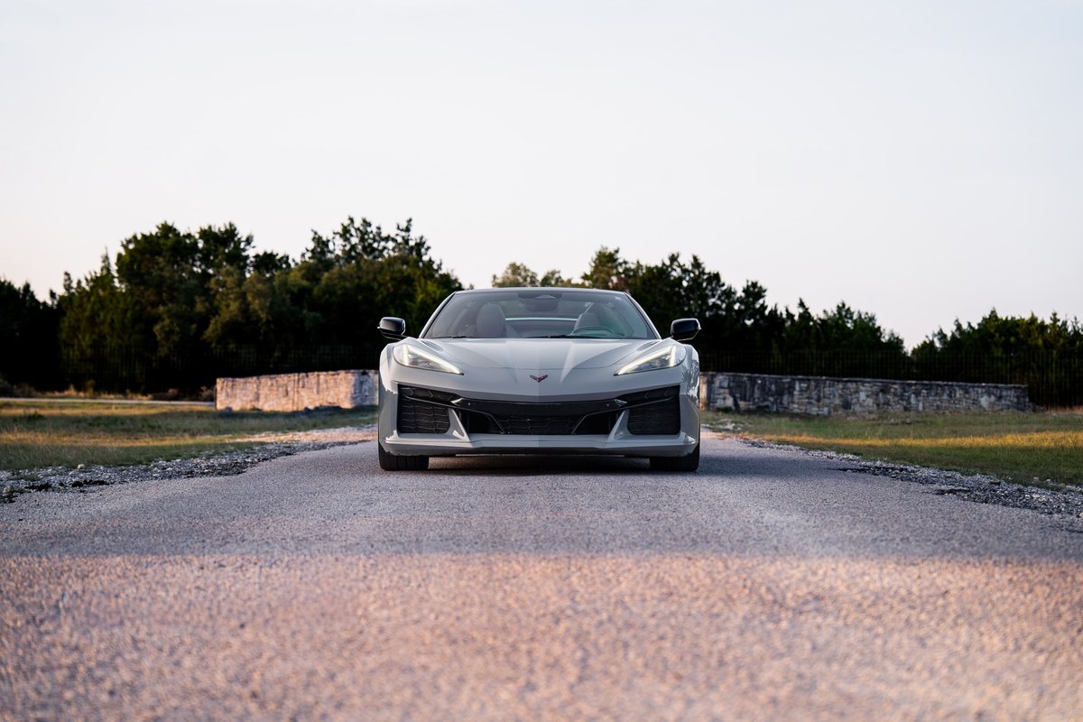 A sea wolf gray 2025 Chevrolet Corvette Z06 with black trim and accents sits on a road.