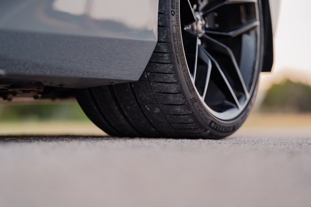 Close-up of a gray 2025 Chevrolet Corvette Z06 tire and black alloy rims.
