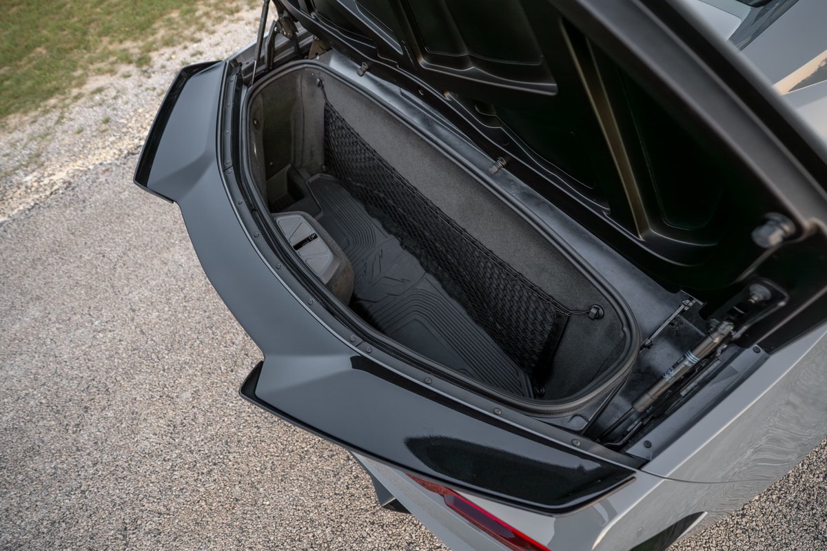 Gray 2025 Corvette Z06 trunk with cargo net and floor mats.