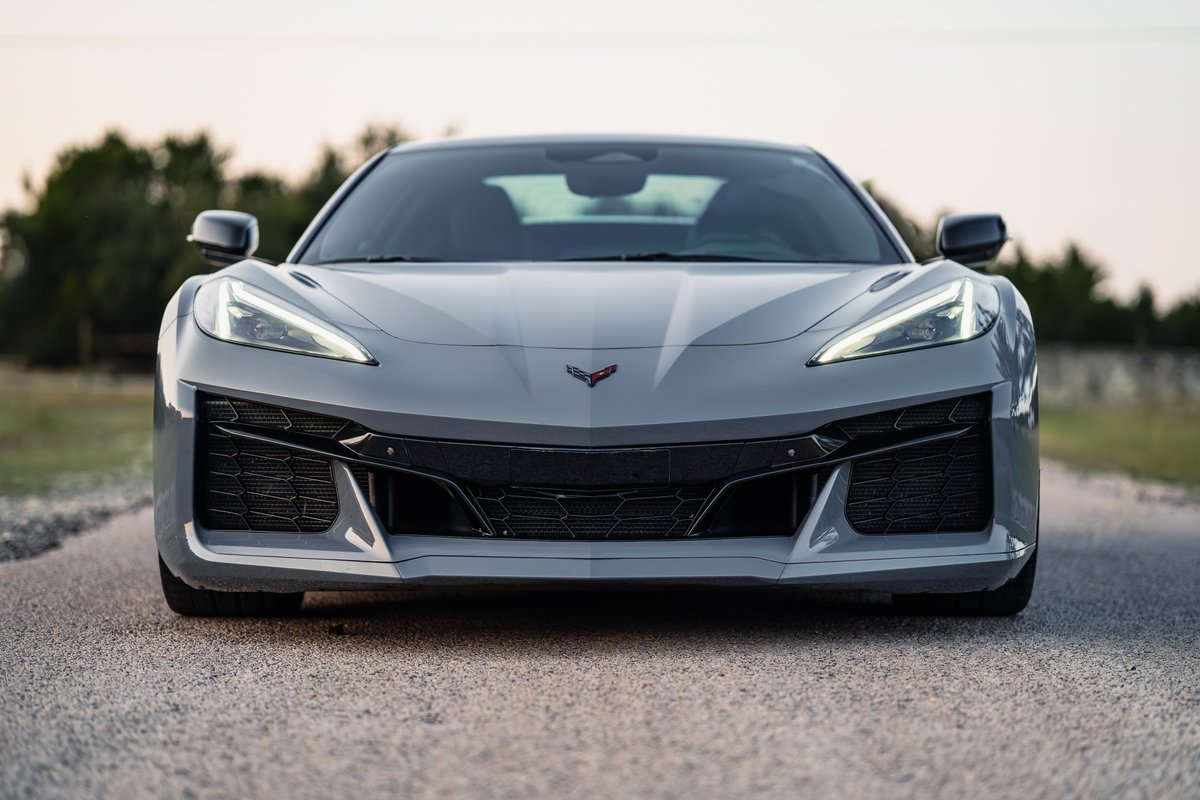 Front view of a Sea Wolf Gray 2025 Chevrolet Corvette Z06. Aggressive front fascia with black trim and large air intakes.