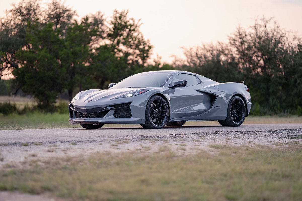 2025 Chevrolet Corvette Z06 in Sea Wolf Gray with black rims and trim on a road.