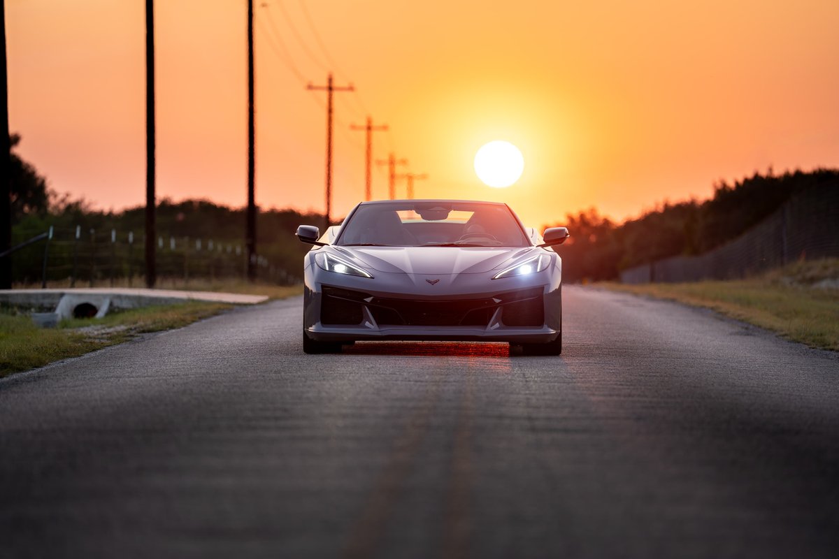 2025 Chevrolet Corvette Z06 in Sea Wolf Gray on a country road at sunset.