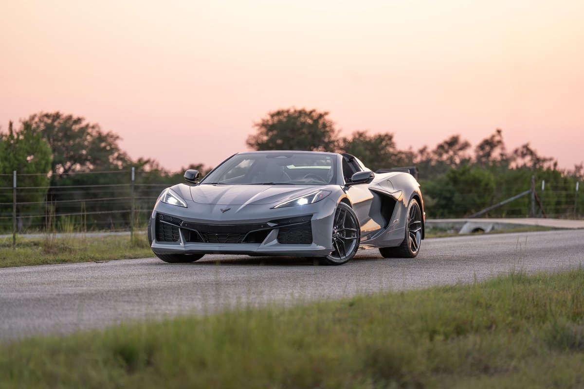 2025 Chevrolet Corvette Z06 convertible in Sea Wolf Gray with performance rims at sunset.