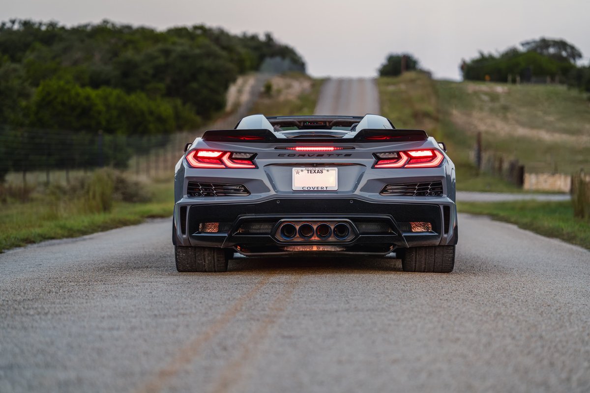 2025 Sea Wolf Gray Corvette Z06 convertible with quad exhaust and aggressive rear trim.
