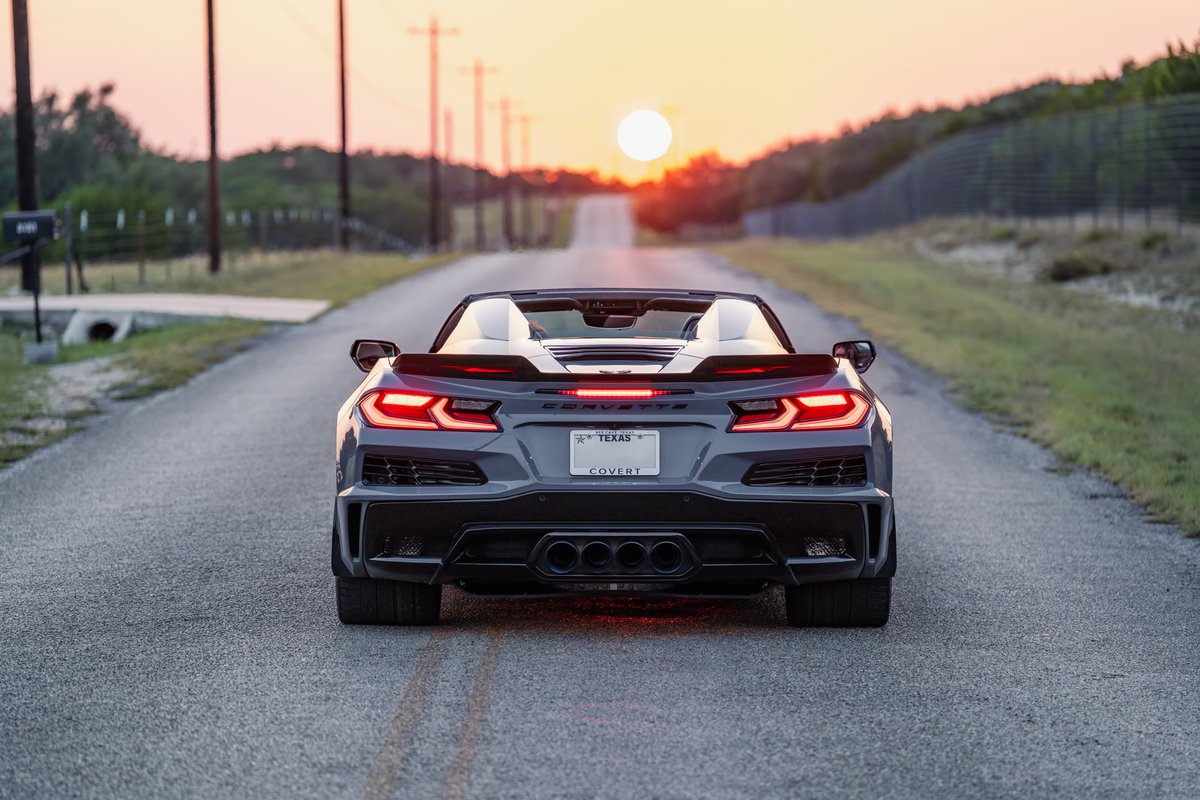 2025 Sea Wolf Gray Chevrolet Corvette Z06 convertible rear view with quad exhaust tips and red LED tail lights.