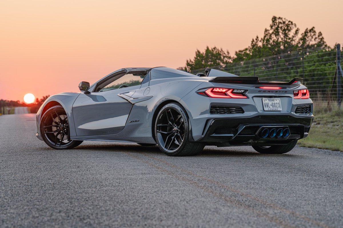 2025 Chevrolet Corvette Z06 convertible in Sea Wolf Gray with black rims and quad exhaust tips.