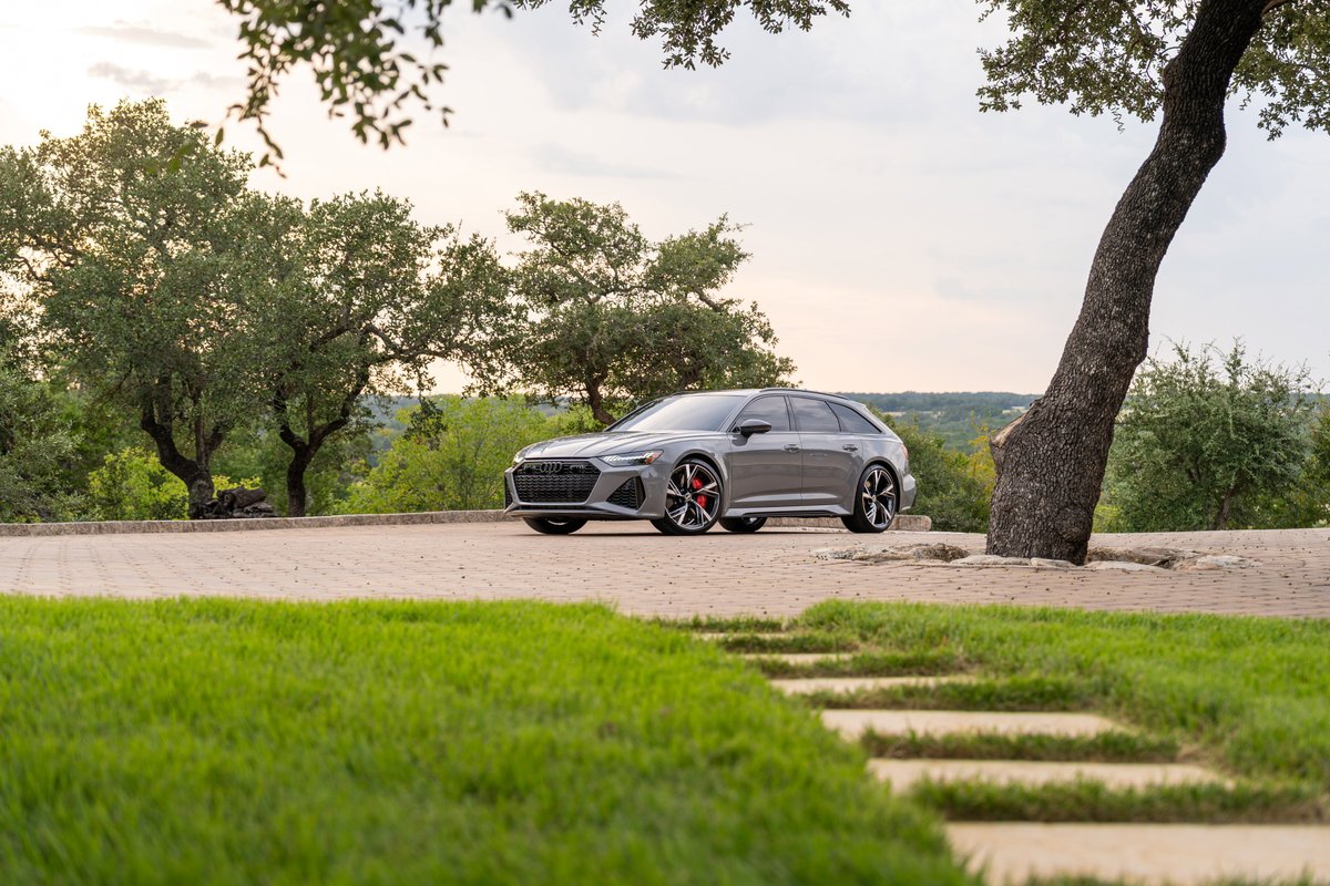 2022 Audi RS6 Avant in Nardo Grey, featuring distinctive black rims and red brake calipers.