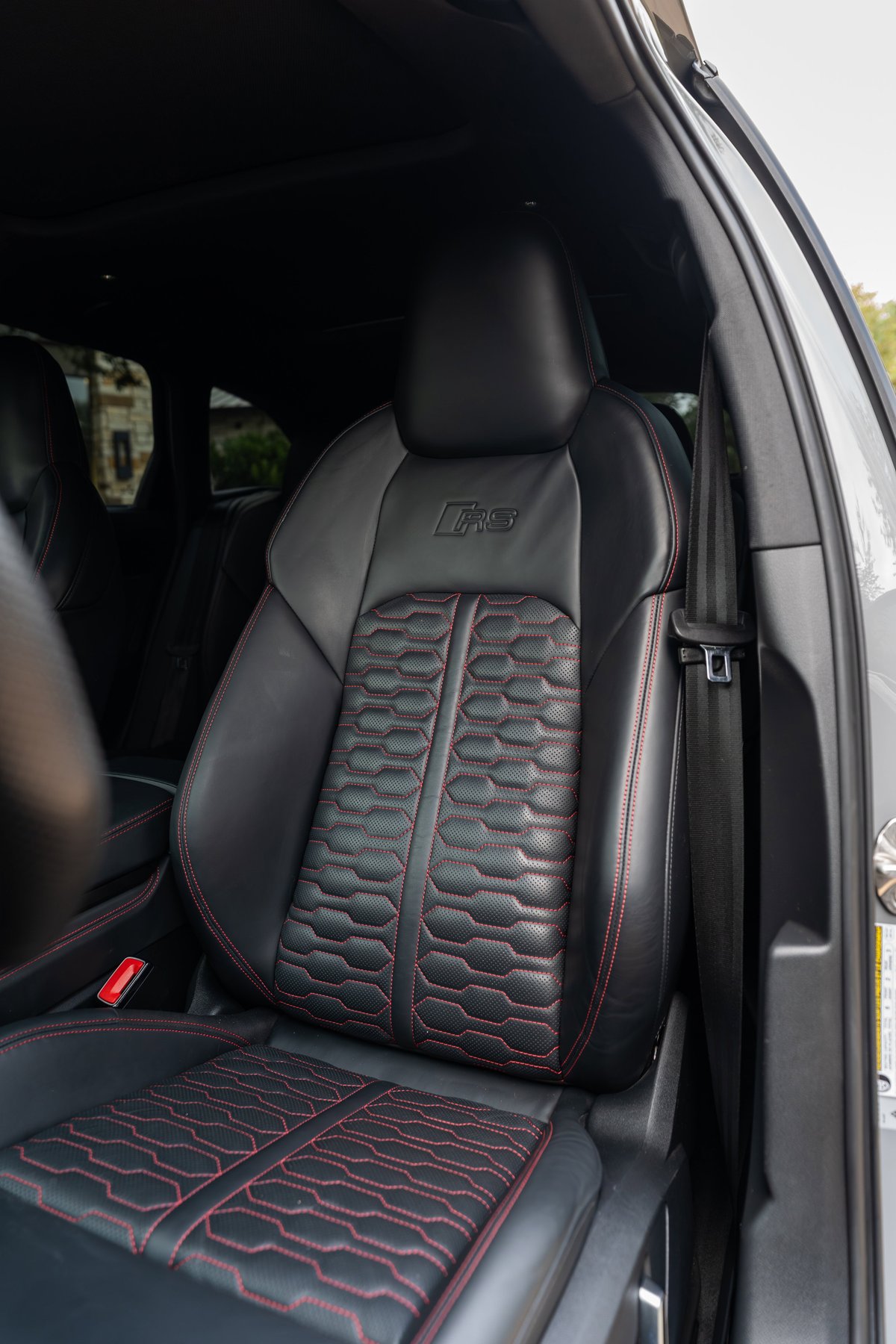 Nardo Grey 2022 Audi RS6 interior: black leather sport seats with red contrast stitching and honeycomb pattern.