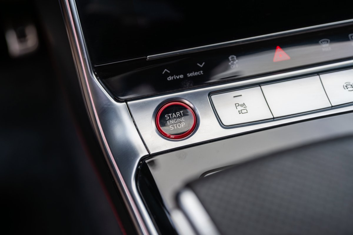 2022 Audi RS6 start/stop button with brushed aluminum trim and red accents.
