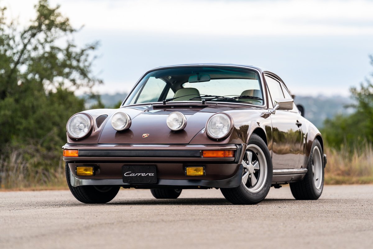 1975 Porsche 911 Carrera in Copper Brown Metallic, featuring rally lights and Fuchs rims.