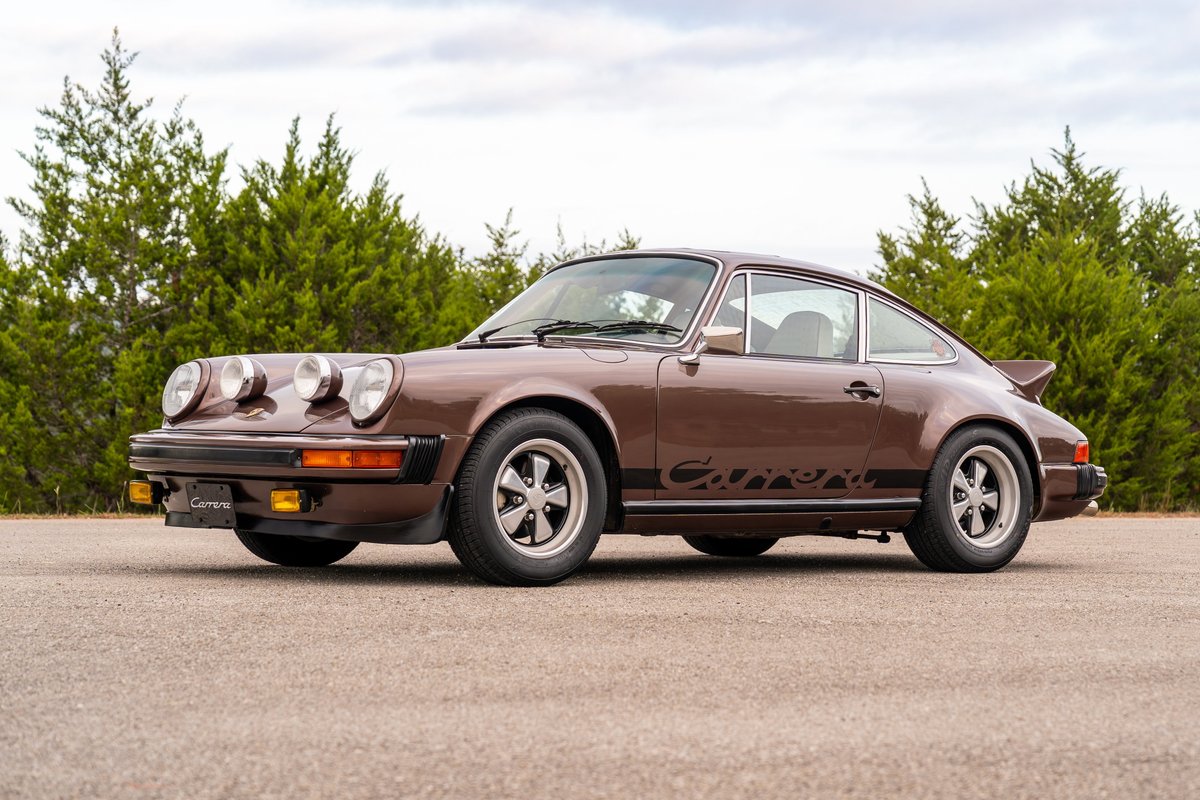 Brown 1975 Porsche 911 Carrera with black livery and Fuchs wheels.