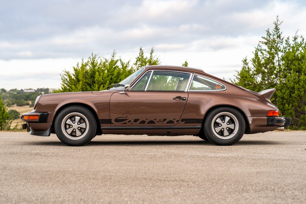 Brown 1975 Porsche 911 Carrera with black "Carrera" side livery and Fuchs rims.