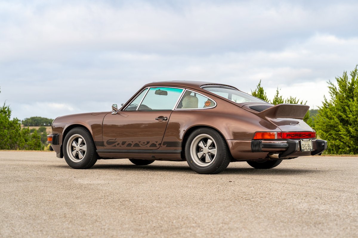 1975 Porsche 911 Carrera in Copper Brown Metallic with black side livery and Fuchs rims.