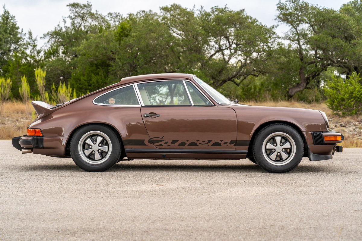 1975 Porsche 911 Carrera in Copper Brown Metallic, side view, black Carrera livery, Fuchs rims.