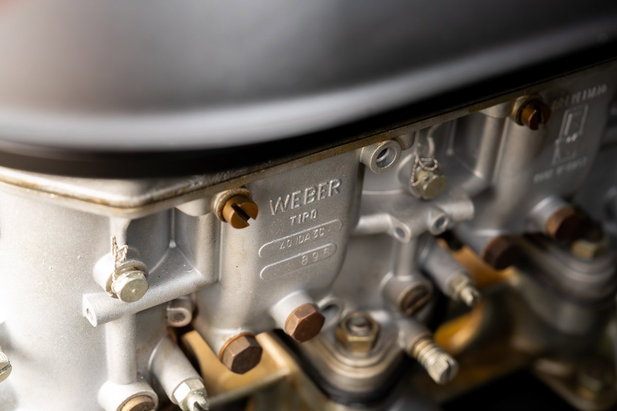Close-up of a vintage Weber carburetor on a 1975 Porsche 911 Carrera.