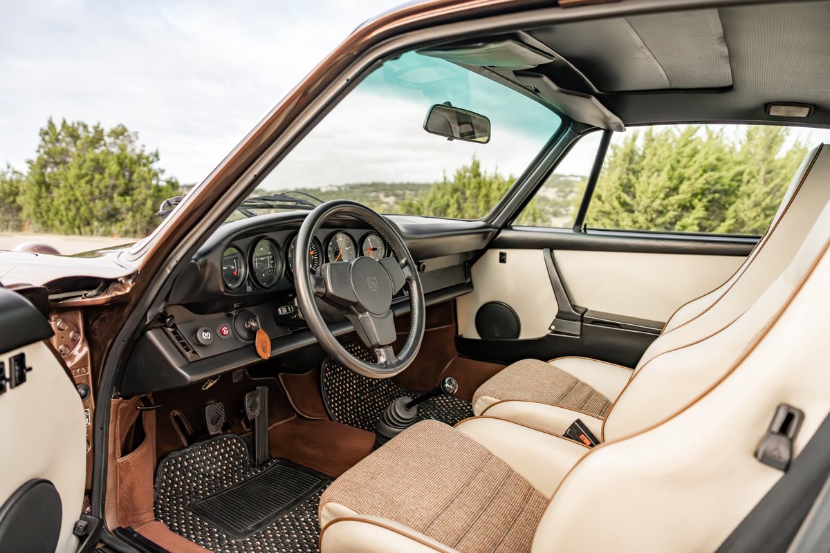 1975 Porsche 911 Carrera interior in copper brown metallic, featuring tan and tweed seats.
