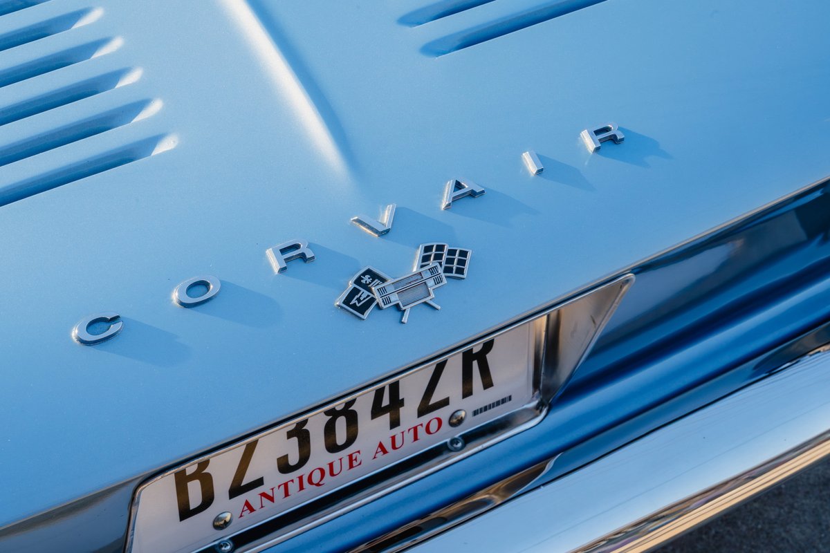 Blue 1966 Chevrolet Corvair convertible hood trim and chrome bumper.