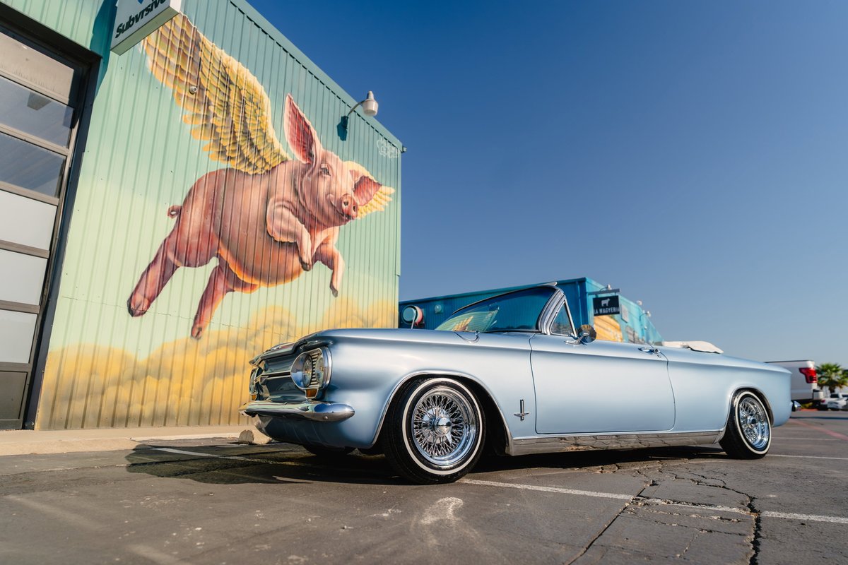1966 Chevrolet Corvair convertible in blue metallic, with wire-spoke rims.