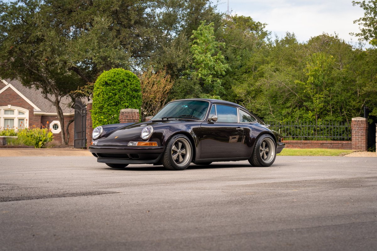 Aubergine Metallic 1990 Singer Porsche 911 with Fuchs-style rims and chrome trim.