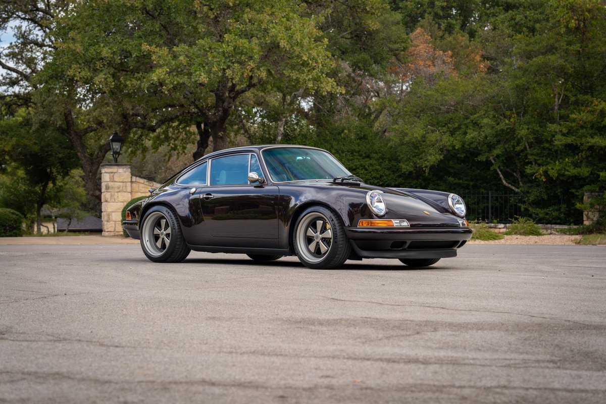 Aubergine metallic 1990 Singer Porsche 911 with five-spoke rims.