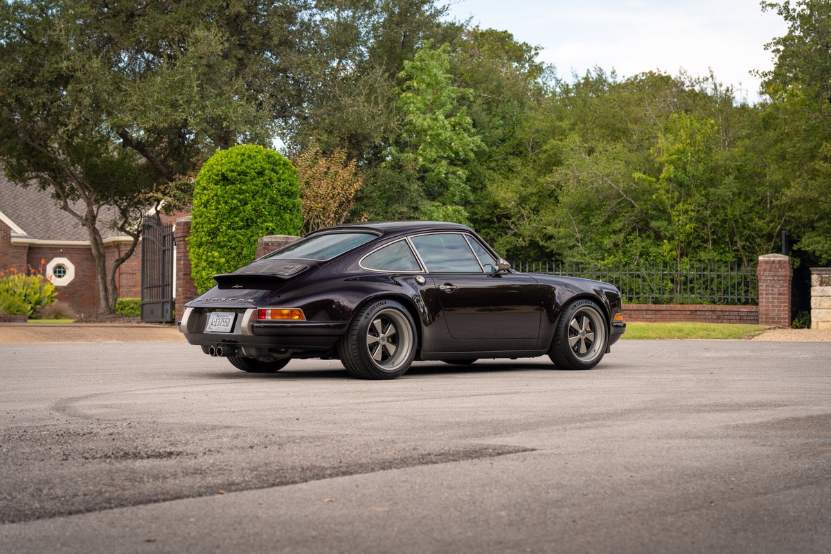 Aubergine Metallic 1990 Singer Porsche 911 with Fuchs wheels and ducktail spoiler.