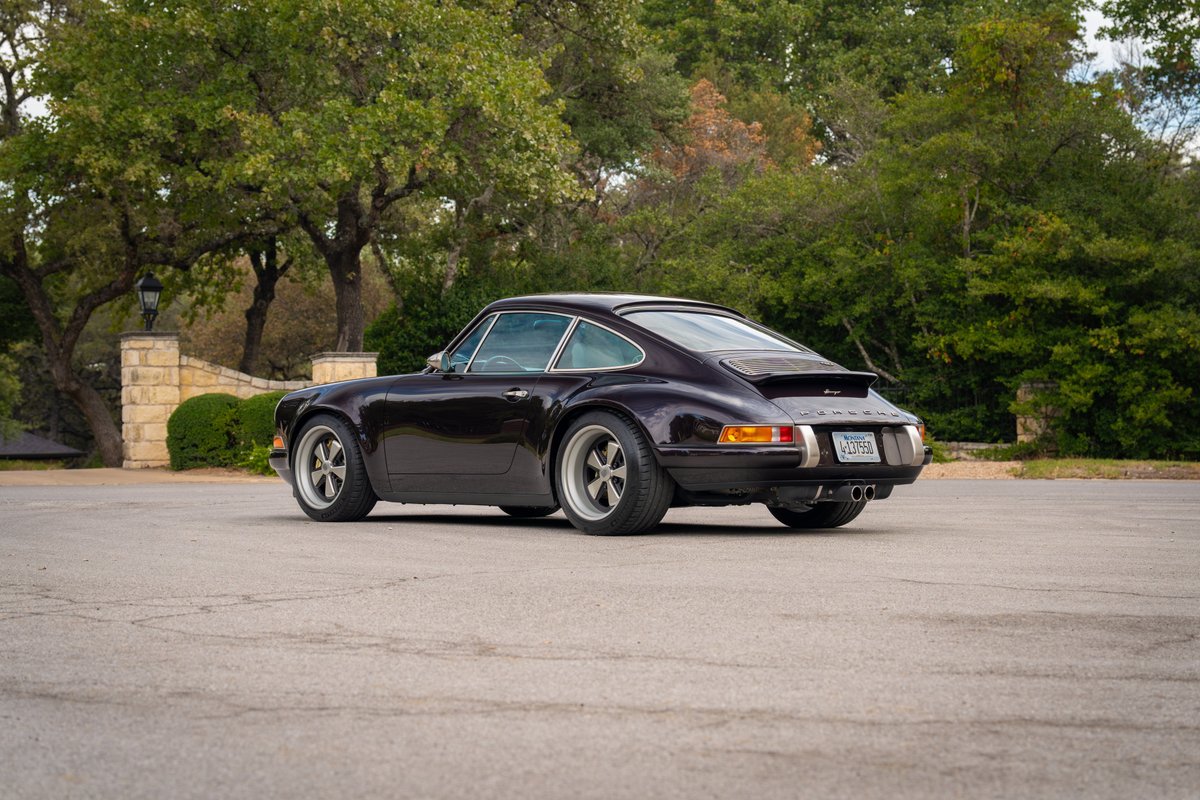 Aubergine metallic 1990 Singer Porsche 911 with chrome trim and Fuchs-style rims.