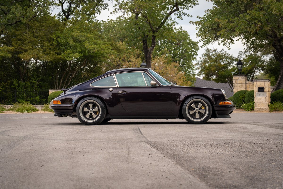 Aubergine metallic 1990 Singer 911 side profile with Fuchs rims and ducktail spoiler.