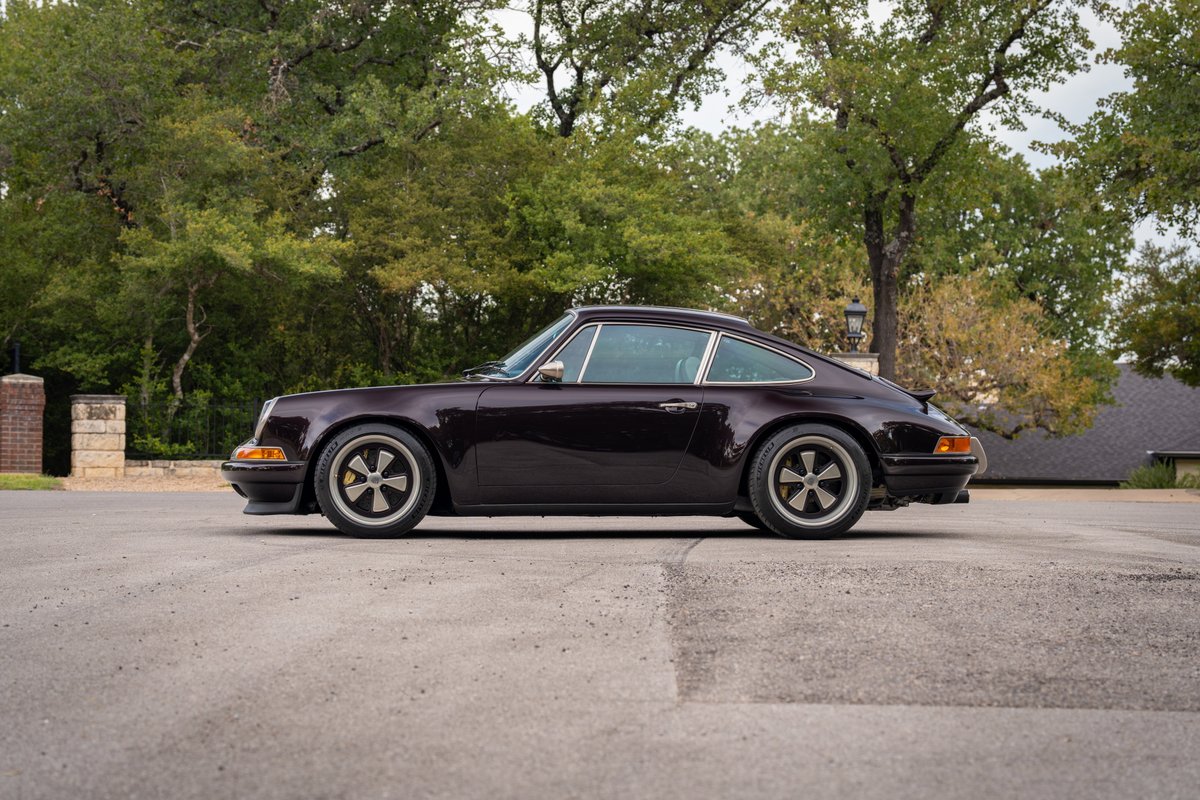 Aubergine metallic 1990 Singer Porsche 911 profile with Fuchs style rims.