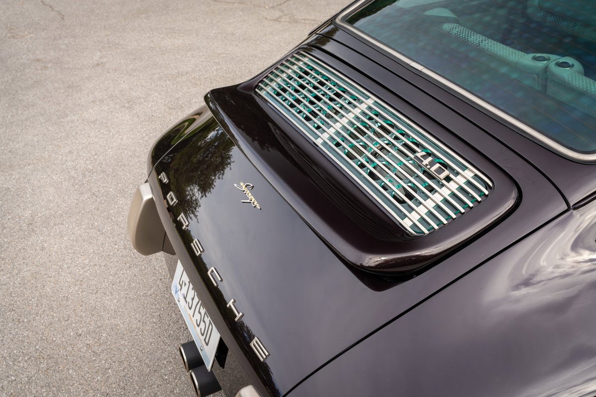 Close-up of a purple metallic 1990 Singer Porsche 911's rear engine lid.