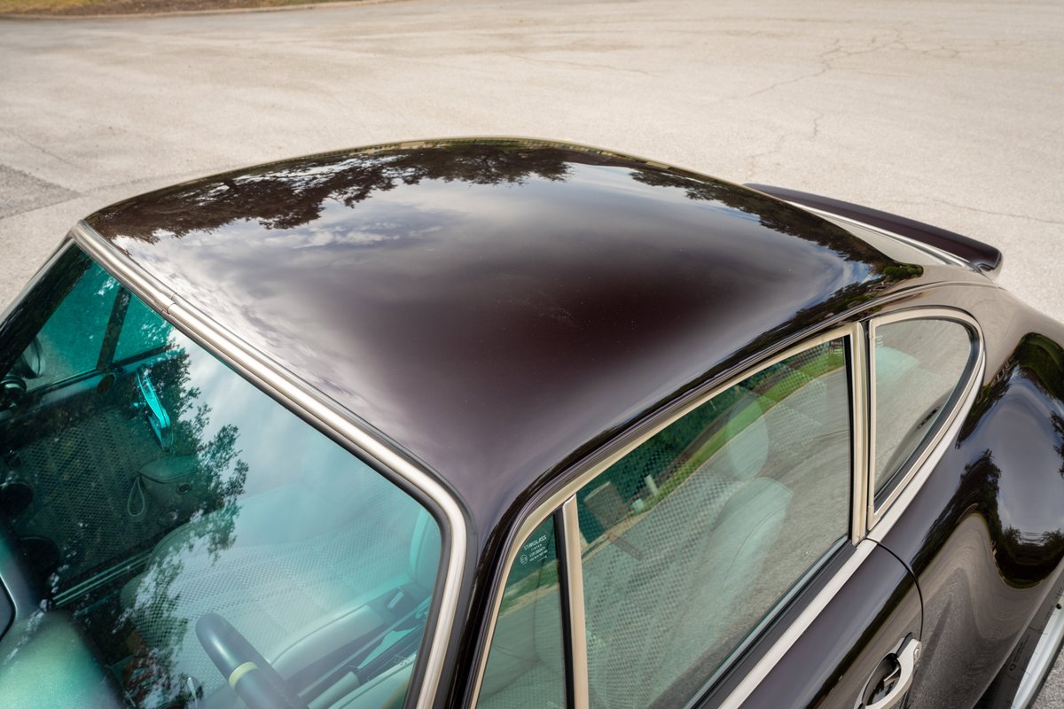 Aubergine Metallic 1990 Singer Porsche 911 coupe roof and windows, showing chrome trim.