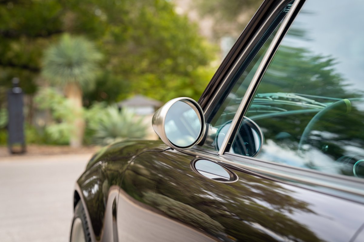 Aubergine metallic 1990 Singer 911 fender with chrome trim and side mirror.