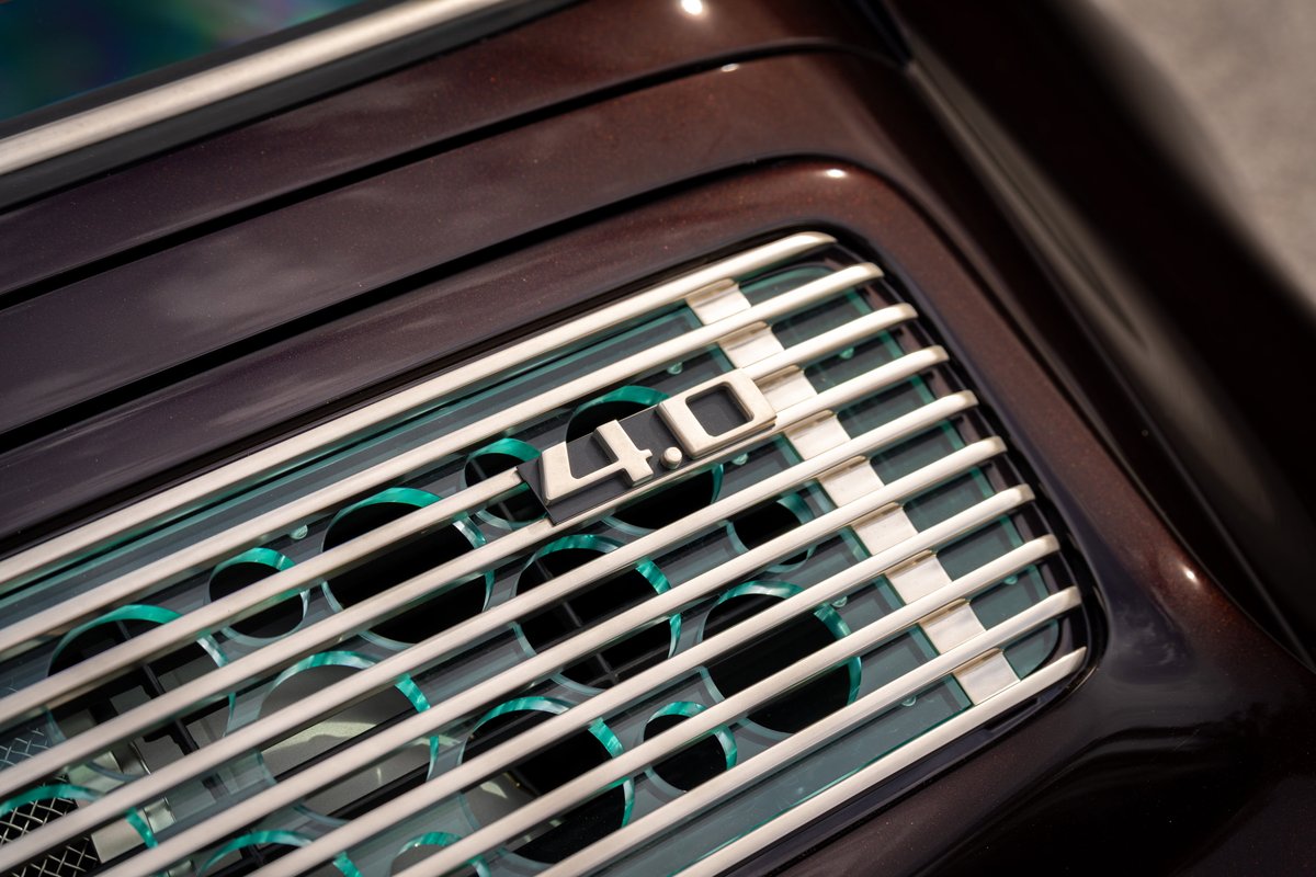 Close up of a Singer 911's aubergine metallic rear grille with "4.0" badging.
