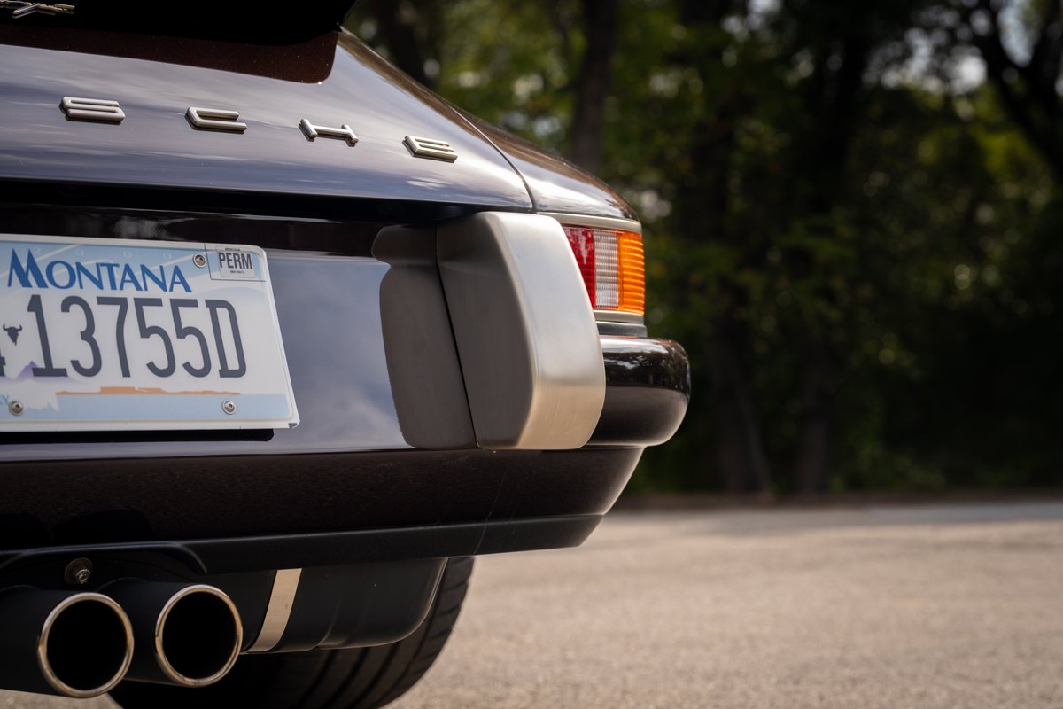 Aubergine metallic 1990 Singer 911 rear with dual exhaust pipes and Montana license plate.