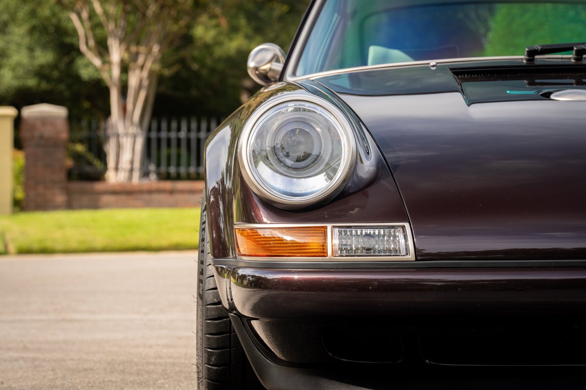 Aubergine metallic 1990 Singer Porsche 911 front fender and headlight detail.