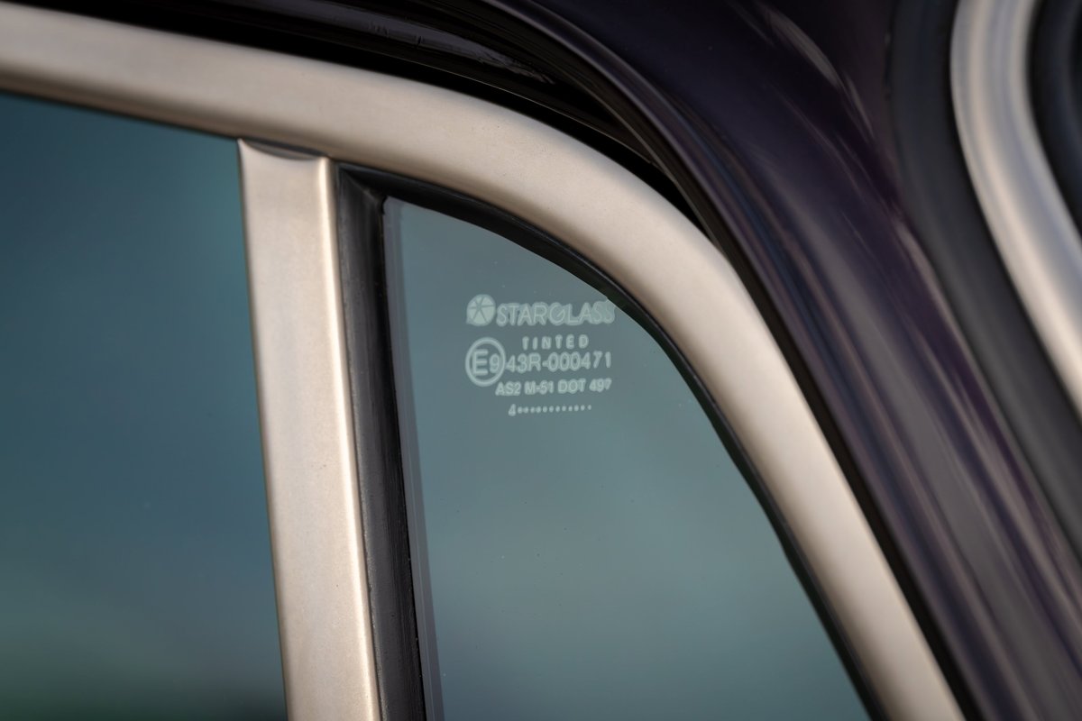 Close-up of a tinted Singer Porsche 911 window trim.