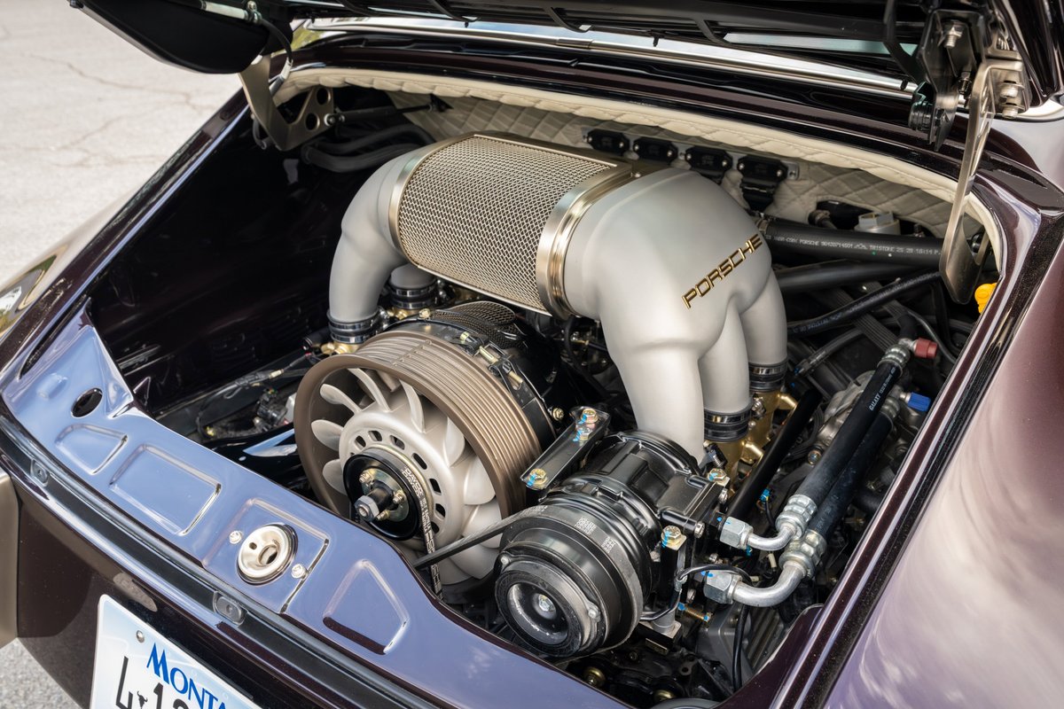 Aubergine metallic 1990 Singer Porsche 911 engine bay with Porsche badging on intake.