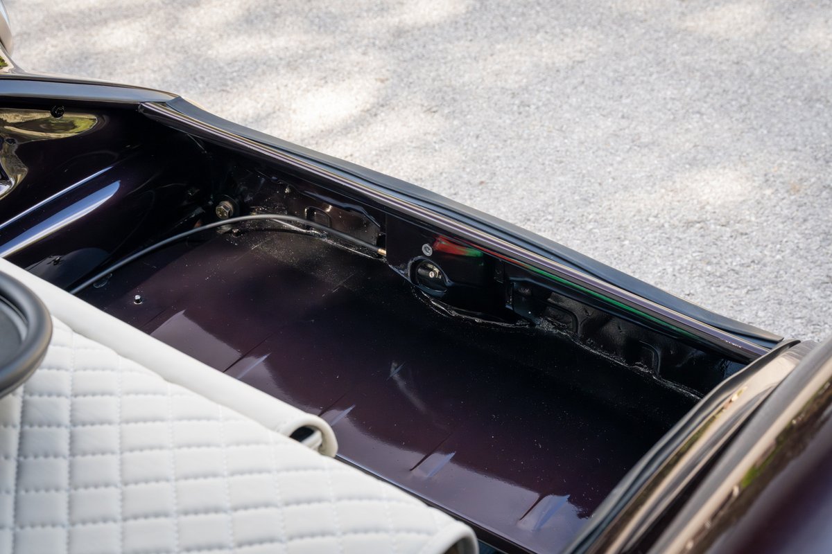 Close-up of the trunk of an aubergine metallic 1990 Singer Porsche 911.